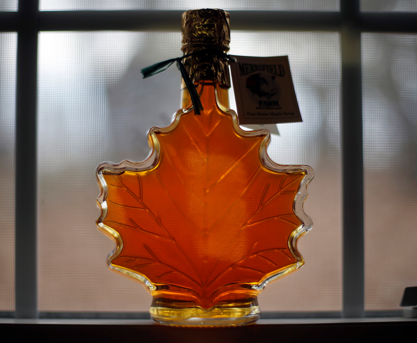 bottle of maple syrup shaped like a maple leaf