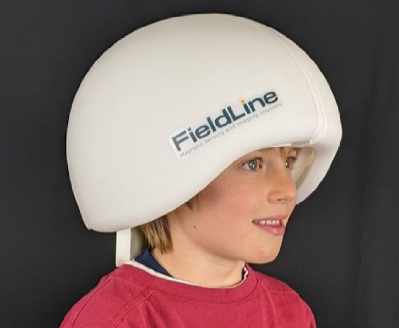 Smiling child wearing a HEDscan system helmet by Colorado Manufacturer FieldLine.